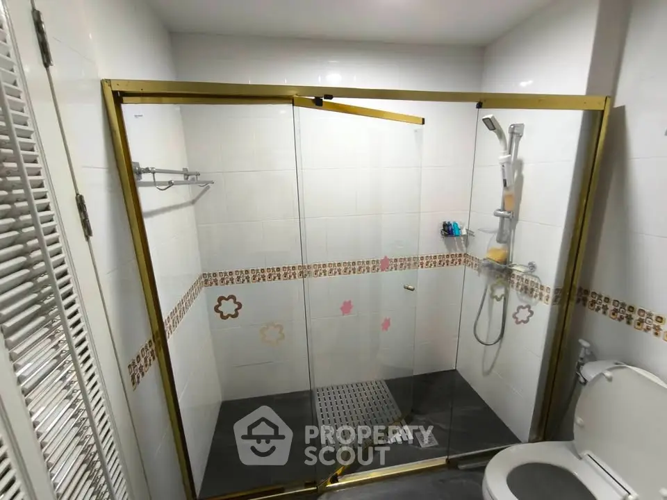 Modern bathroom with glass shower enclosure and stylish tile accents