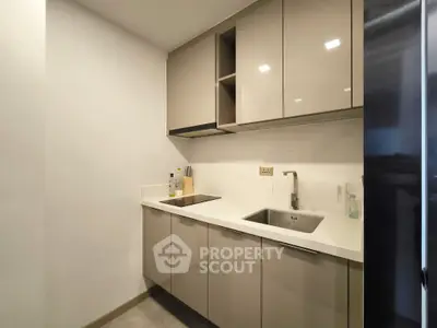 Modern kitchen with sleek cabinetry and integrated appliances