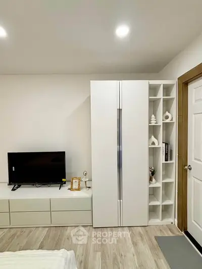 Modern bedroom with sleek white furniture and stylish decor