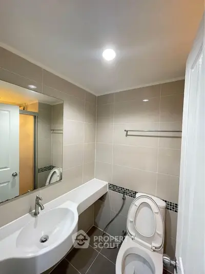 Modern bathroom with sleek fixtures and neutral tile design