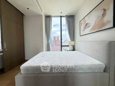Modern bedroom with large window and city view, featuring stylish decor and natural light.