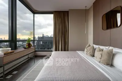 Luxurious bedroom with panoramic city view and elegant decor.