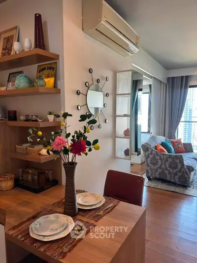 Chic living room with stylish decor, cozy seating, and modern air conditioning in a bright apartment.