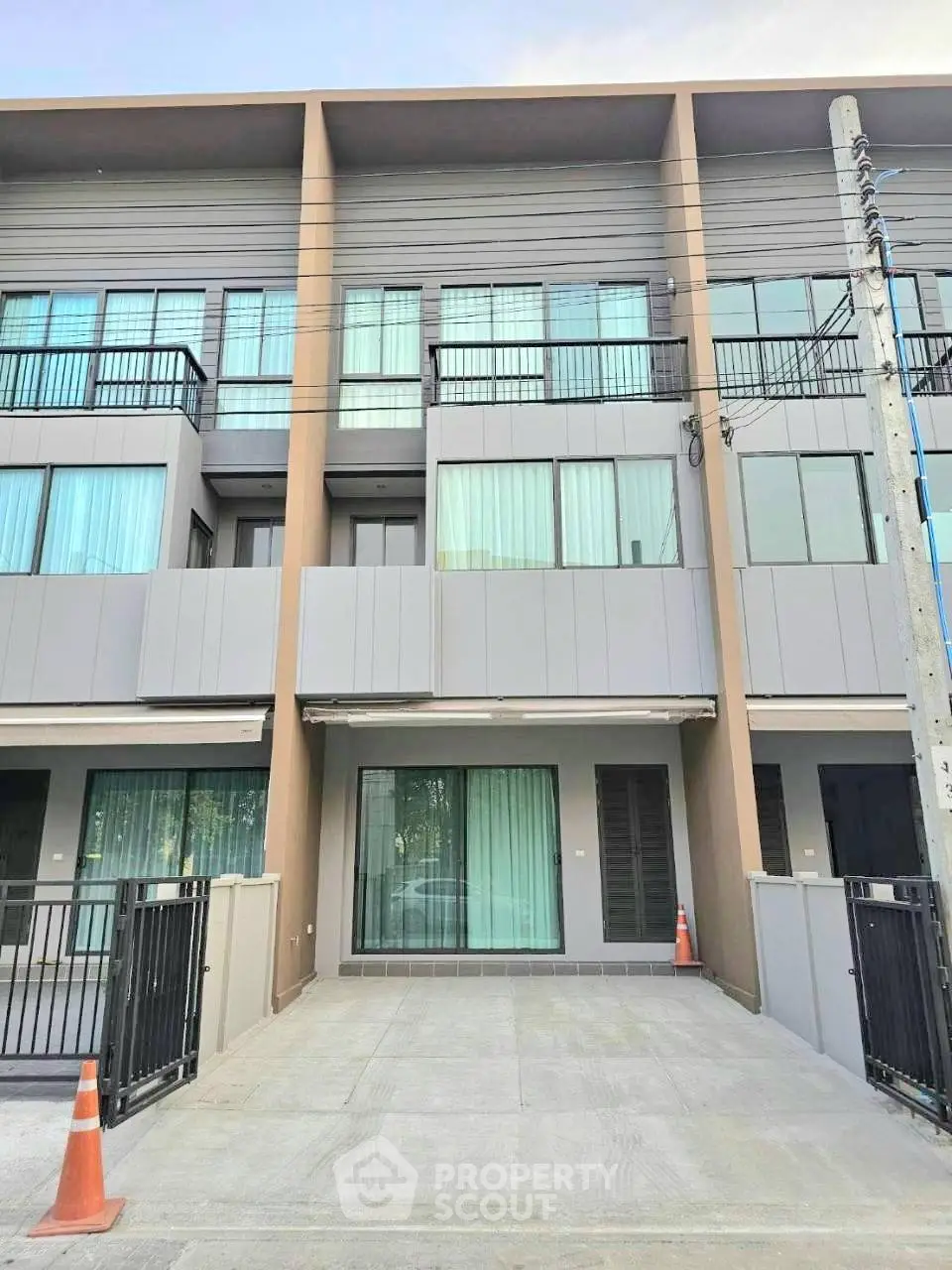 Modern townhouse exterior with sleek design and spacious driveway