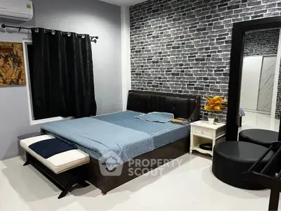 Stylish bedroom with modern decor and brick accent wall