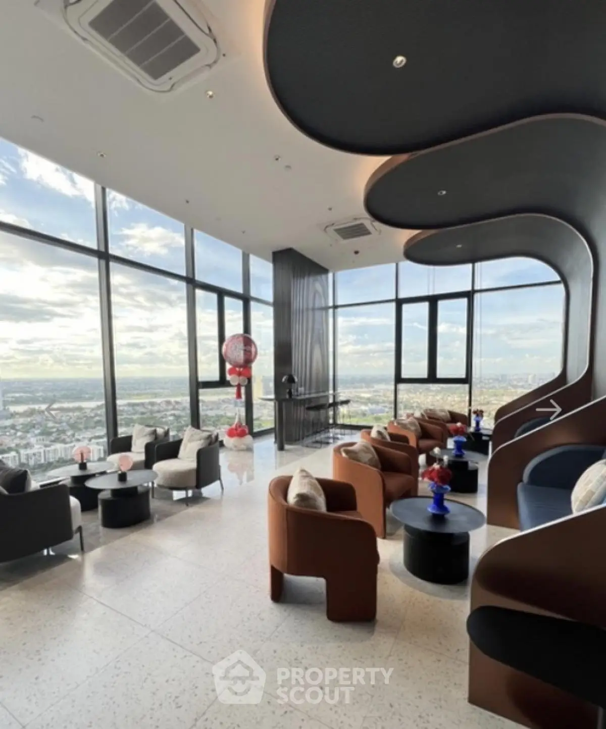 Luxurious high-rise lounge with panoramic city views and modern seating
