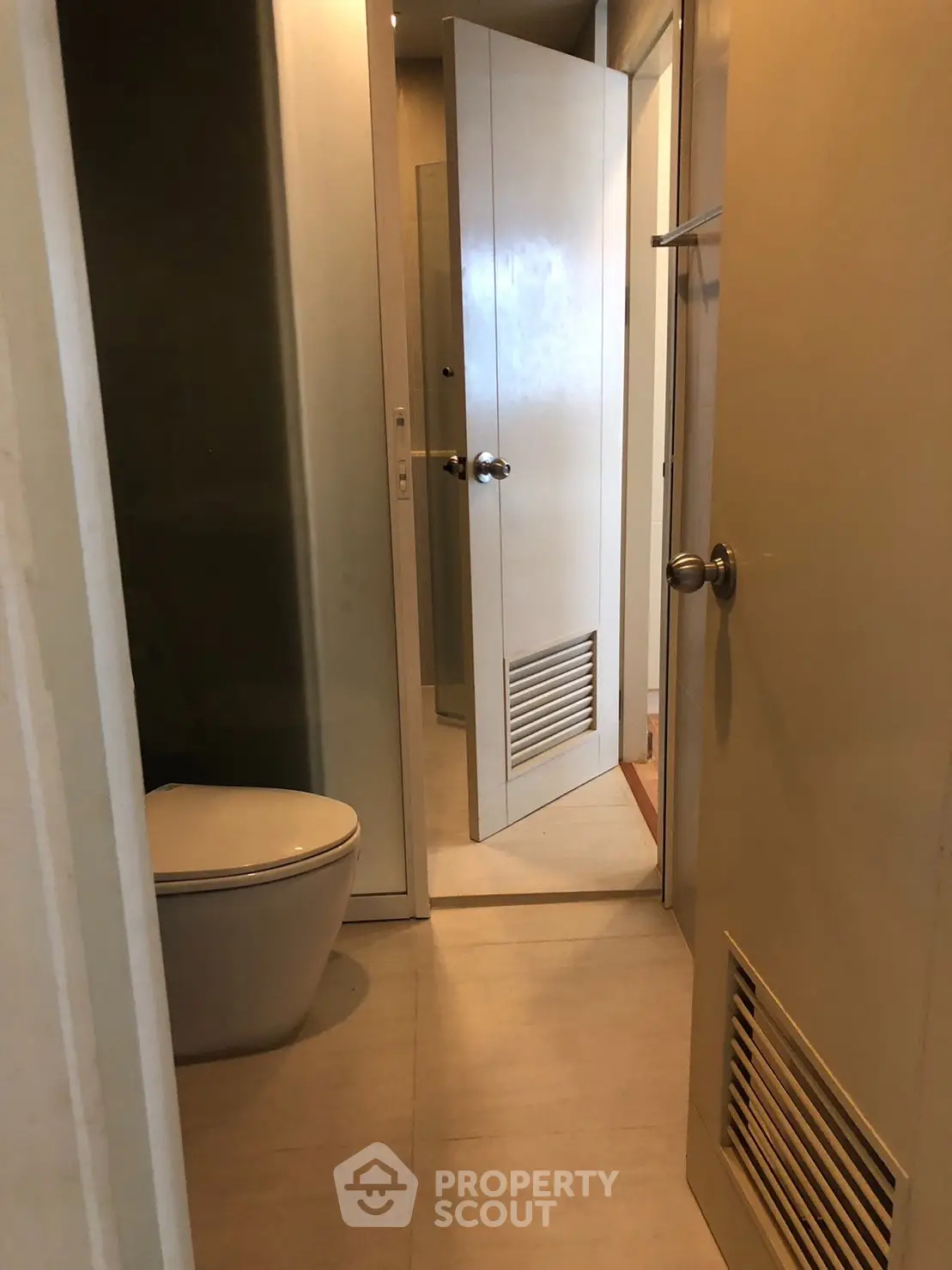 Modern bathroom with sleek design and minimalist fixtures, featuring a concealed toilet area.