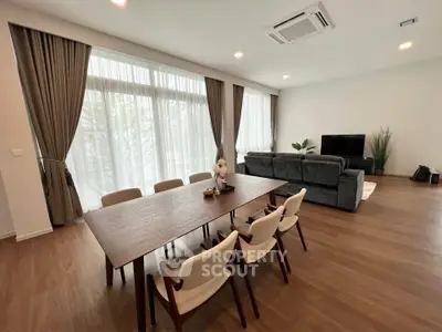 Spacious modern living room with elegant dining area and large windows