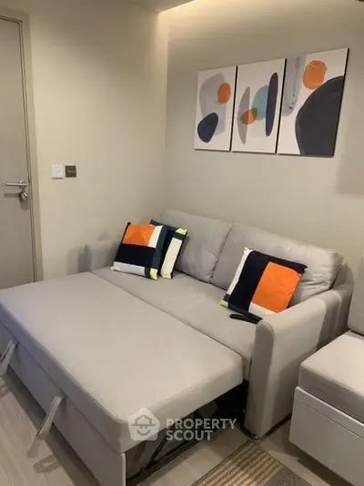 Modern living room with stylish sofa bed and abstract wall art