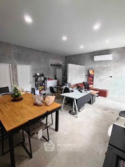 Spacious modern living area with stylish decor and ample natural light.