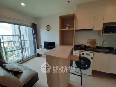 Modern studio apartment with open kitchen and balcony view