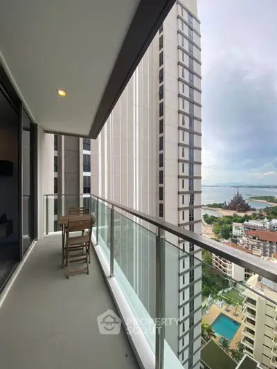 Spacious balcony with stunning city and sea view, perfect for relaxation and outdoor dining.