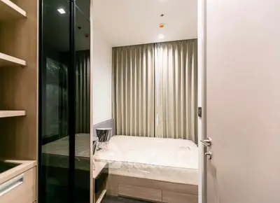 Modern bedroom with sleek design and ample natural light, featuring a comfortable bed and stylish decor.