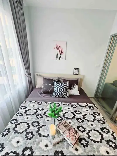 Cozy bedroom with stylish decor and natural light, perfect for relaxation and comfort.