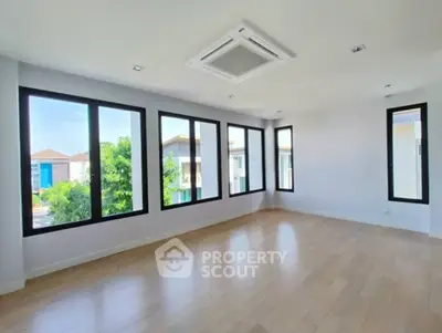 Spacious room with large windows offering abundant natural light and scenic views.