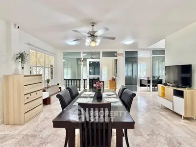 Spacious open-plan living and dining area with modern furnishings and ample natural light.