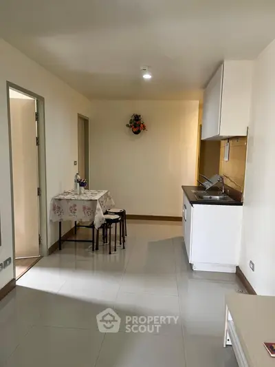 Cozy compact kitchen with dining area in modern apartment