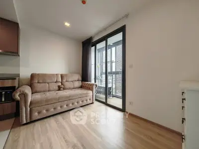 Modern living room with cozy sofa and balcony access
