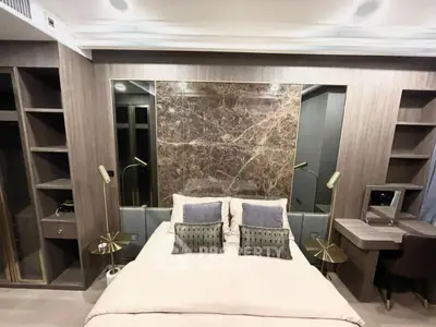 Luxurious bedroom with elegant marble accent wall and modern lighting