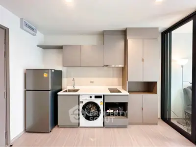 Modern kitchen with sleek cabinetry, built-in appliances, and stylish design in a contemporary apartment.