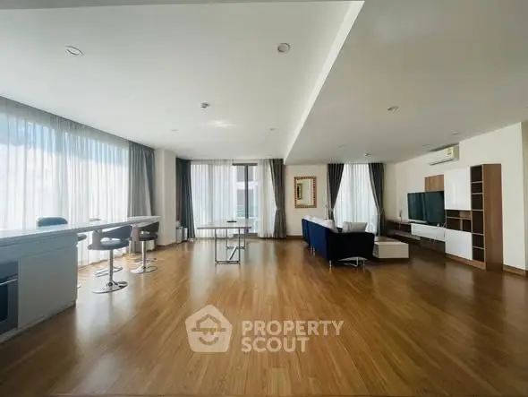 Spacious modern living room with large windows and stylish furniture