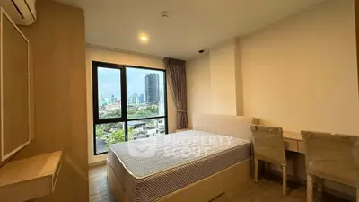 Modern bedroom with city view, featuring a comfortable bed and stylish furnishings.