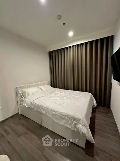 Modern bedroom with sleek design and cozy ambiance, featuring a comfortable bed and stylish flooring.
