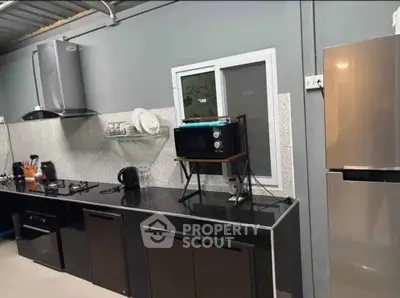 Modern kitchen with sleek black countertops and stainless steel appliances