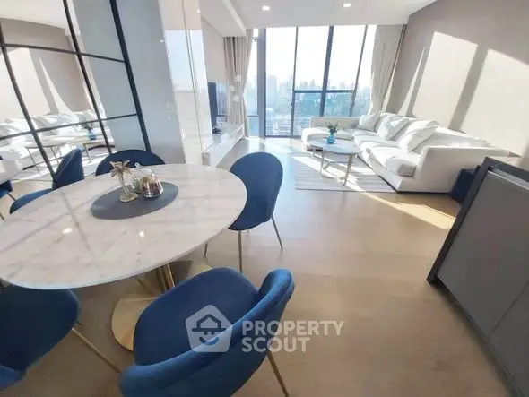 Luxurious modern living room with elegant dining area and stunning city view.
