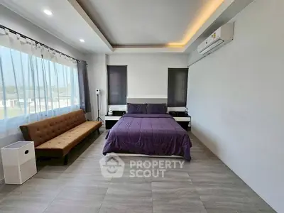 Spacious modern bedroom with large windows and stylish decor