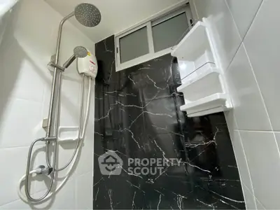 Modern bathroom with sleek black marble wall and rainfall showerhead