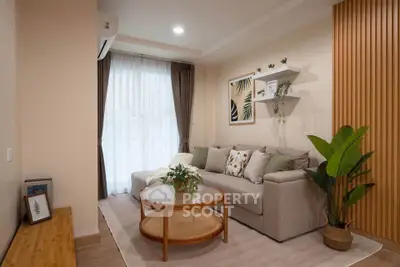 Cozy living room with modern decor, featuring a comfortable sofa, stylish coffee table, and elegant wall art.