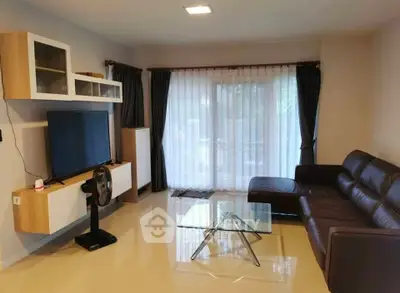 Modern living room with sleek furniture and large window for natural light.