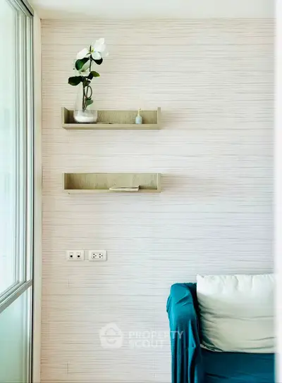 Modern living room corner with minimalist decor and wall shelves