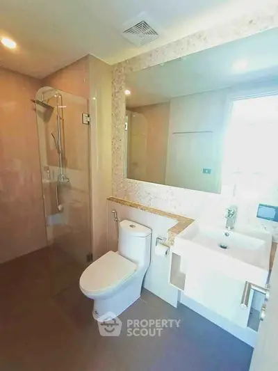 Modern bathroom with glass shower and large mirror