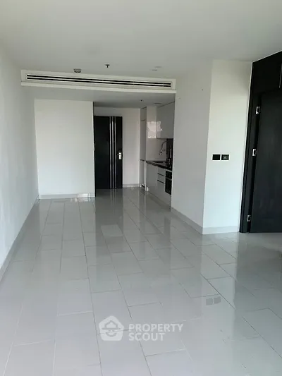 Spacious modern apartment with sleek kitchen and open layout, perfect for contemporary living.