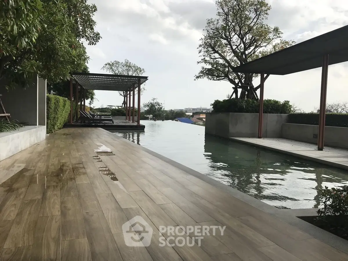 Luxurious rooftop pool with stunning city views and elegant wooden deck.
