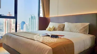 Luxurious bedroom with stunning city view, featuring a cozy bed and modern decor.