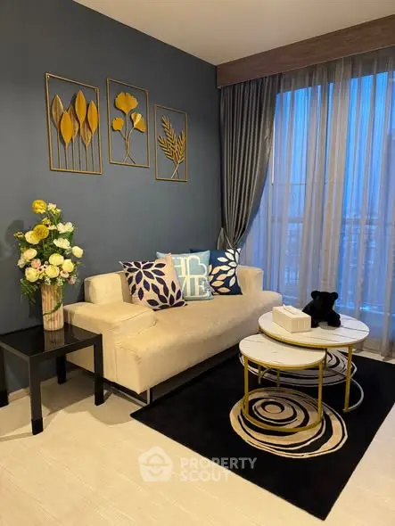 Stylish modern living room with elegant decor and large window view.