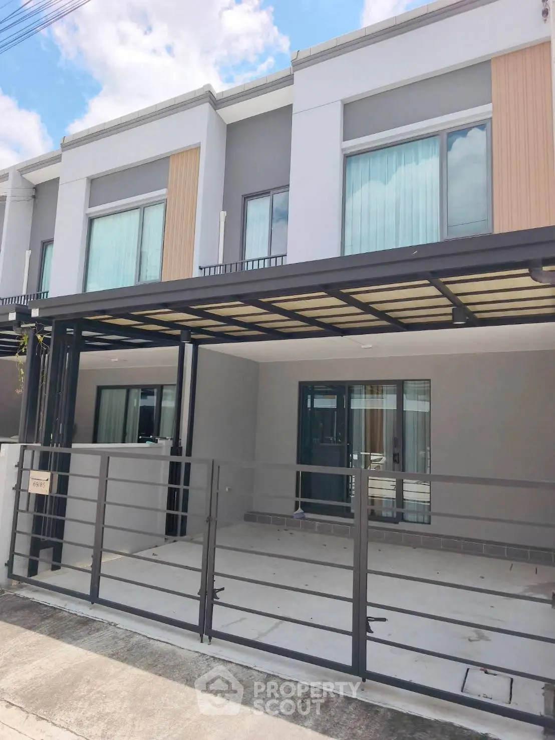 Modern townhouse exterior with sleek design and spacious driveway