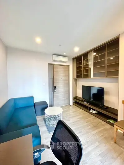Modern living room with sleek furniture and built-in storage, perfect for urban living.