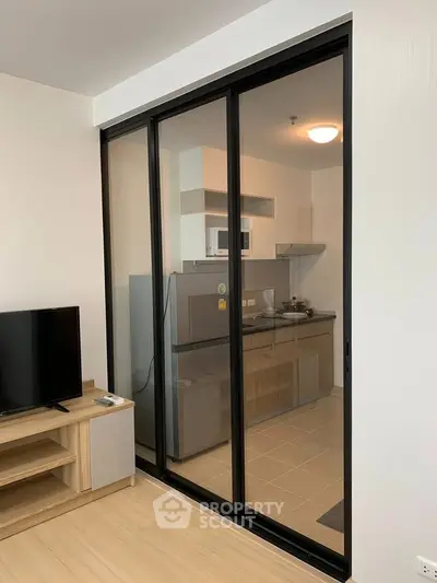Modern open-layout kitchen with sliding glass doors and sleek appliances