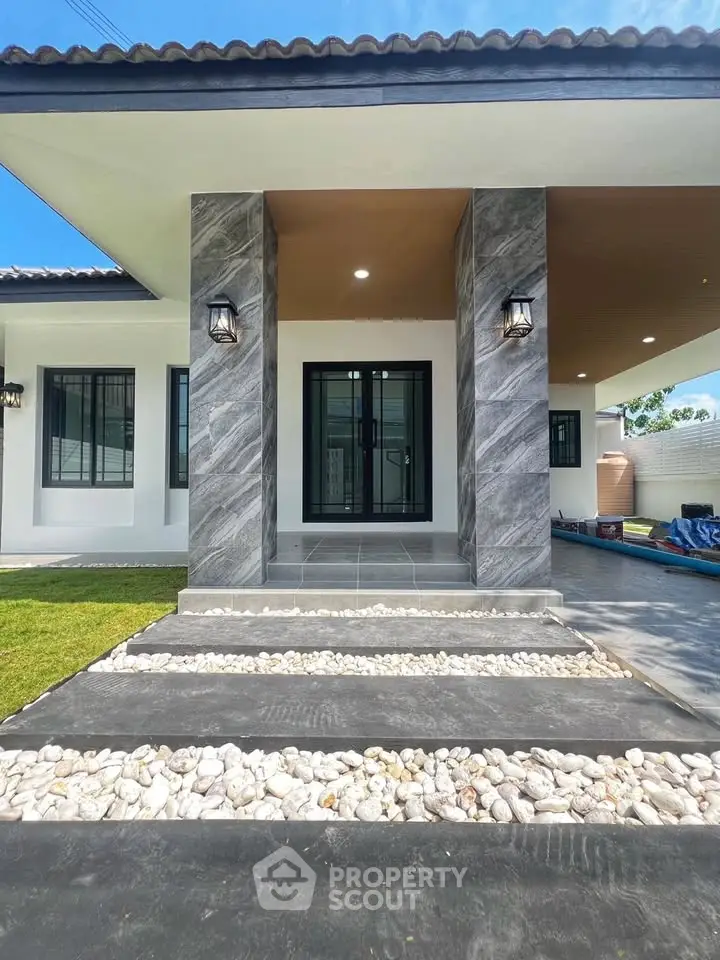 Modern house entrance with stylish stone pillars and sleek lighting