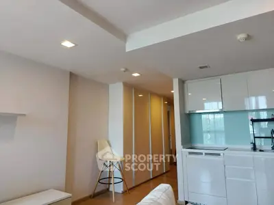 Modern apartment interior with sleek kitchen and stylish bar stool
