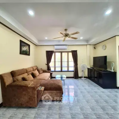 Spacious living room with modern decor, large sofa, and entertainment center, perfect for relaxation.