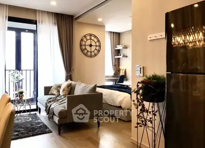 Modern open-plan living room with stylish decor and cozy ambiance in a contemporary apartment.