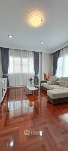 Spacious living room with elegant hardwood floors and modern furniture