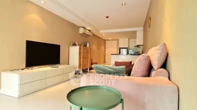 Spacious living room with modern decor and open kitchen layout, perfect for entertaining.