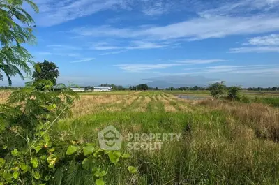 Expansive rural land with lush greenery and clear blue sky, perfect for agricultural development.
