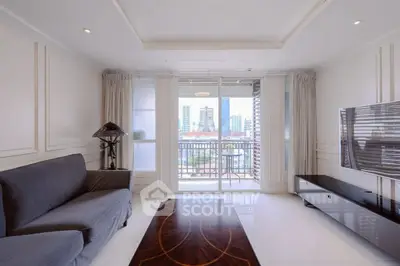 Spacious living room with modern decor and city view balcony.